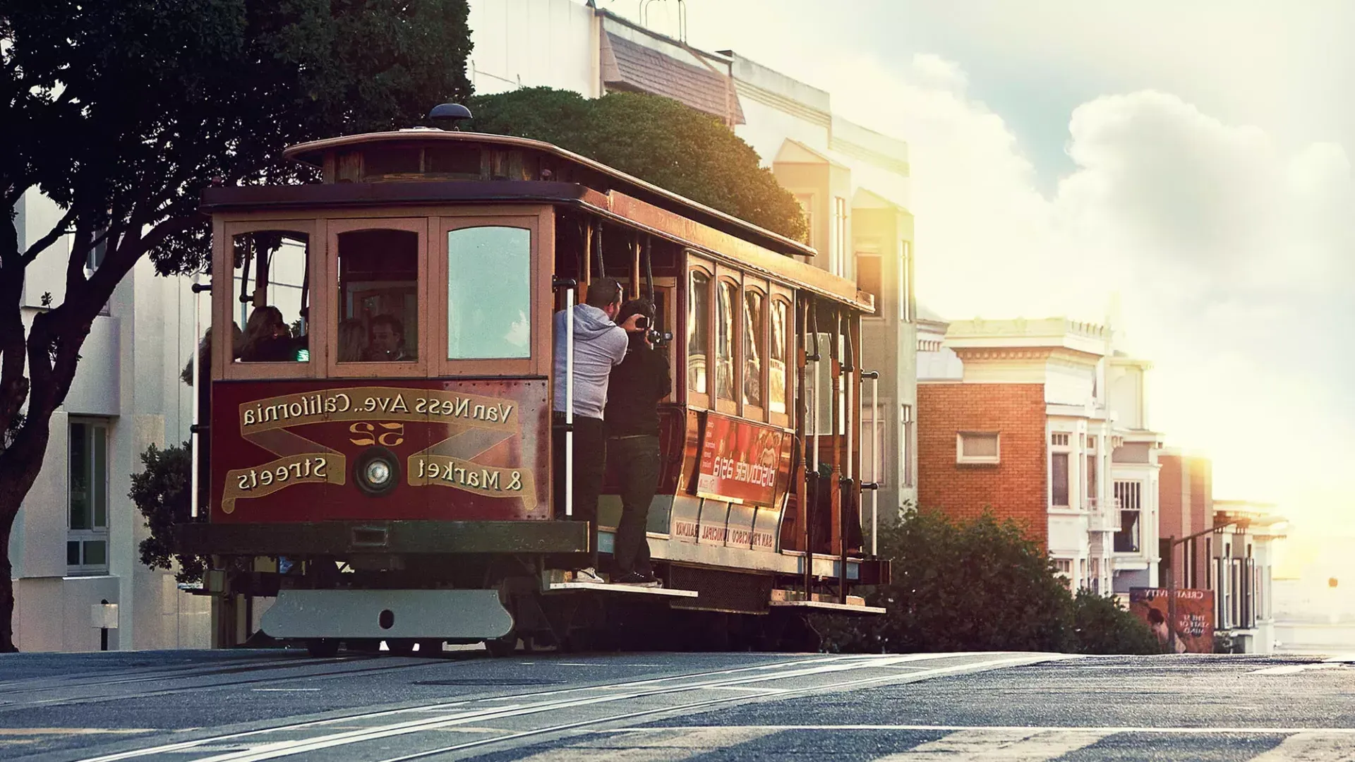 A cable car rounds a hill in 贝博体彩app with passengers looking out the window.