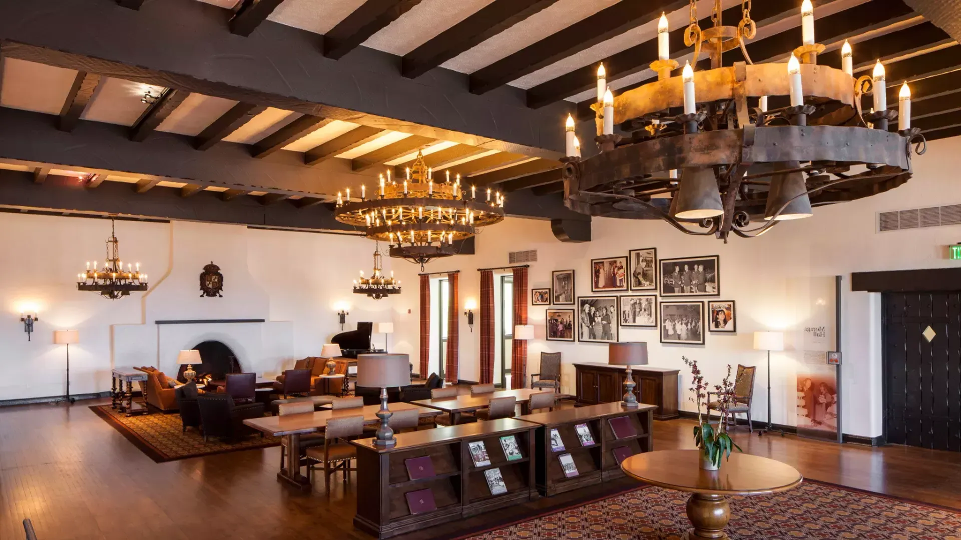 Interior of the historic Presidio Officers' Club, with wood-beam ceilings and large chandeliers.