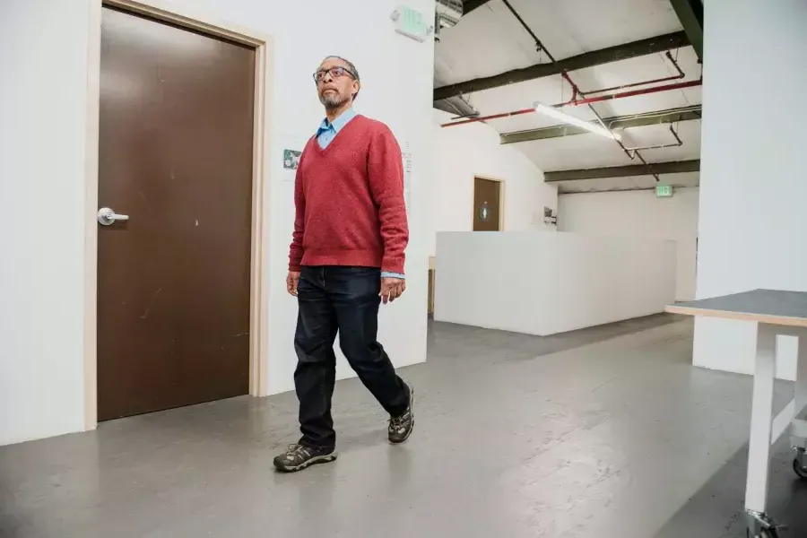 Ron Moultrie Saunders walking in his studio.