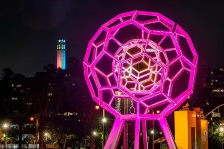 Buckyball shines outside the Exploratorium, with 屁股塔 in the background