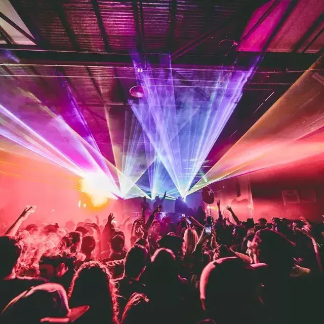 Image of people dating in colorfully lit night club